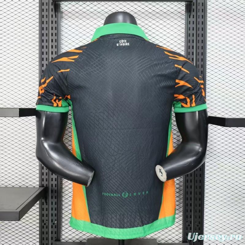 Player Version 2025 Ivory Coast Black with Elephant Graphic and Orange Stripes Jersey